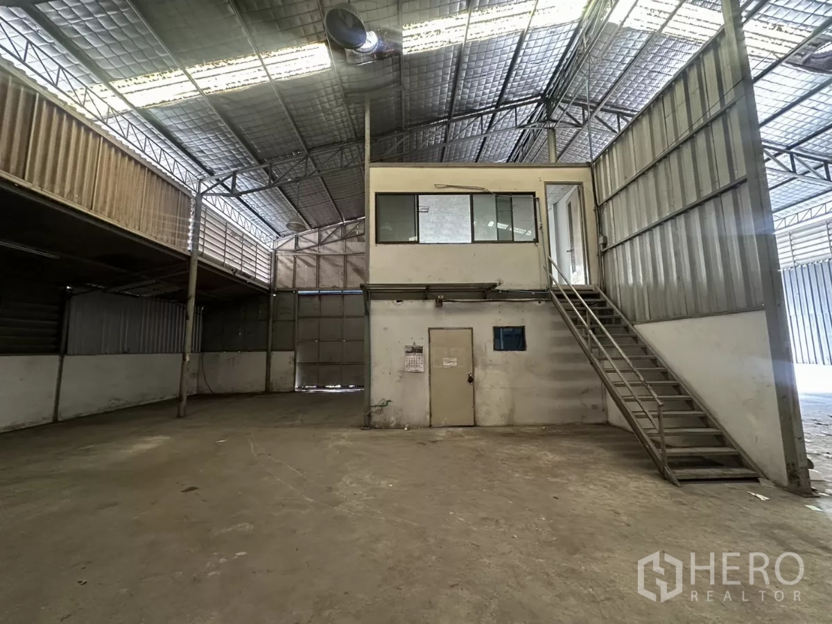 Warehouse for rent in Suan Luang, Bangkok - Internal two-storey office box with metal staircase inside the warehouse.