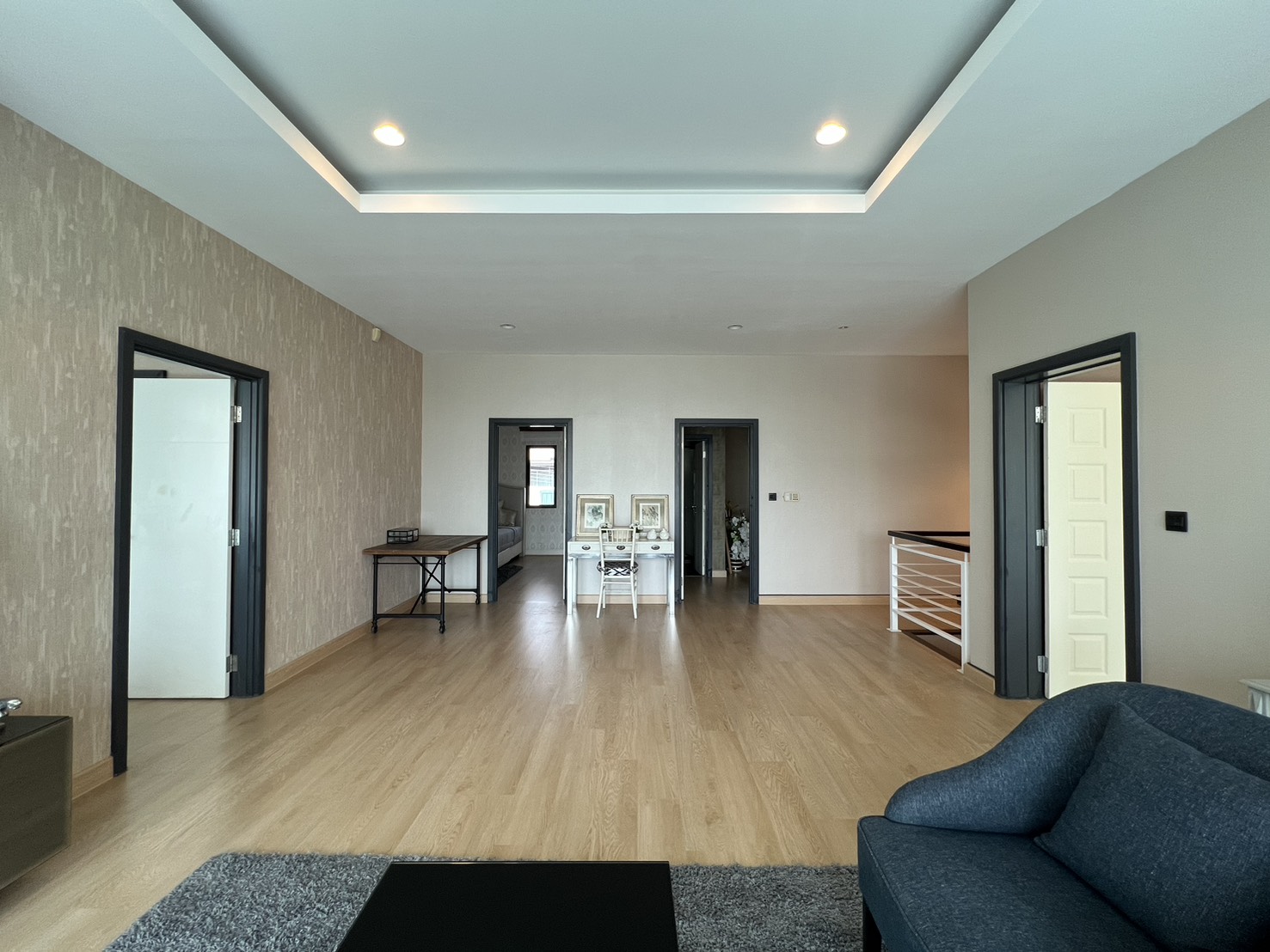 Detached House for rent in Bang Kapi, Bangkok - Upper floor hall connecting multiple bedrooms with wood flooring.