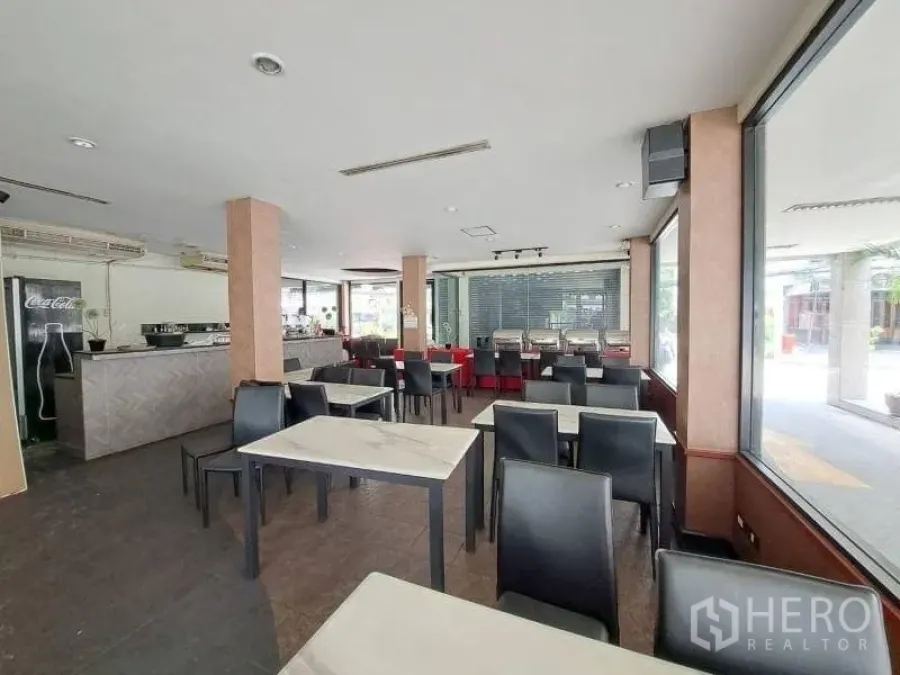 Retail Space for rent - Spacious dining hall with bar counter, air‑conditioning units and floor‑to‑ceiling windows.