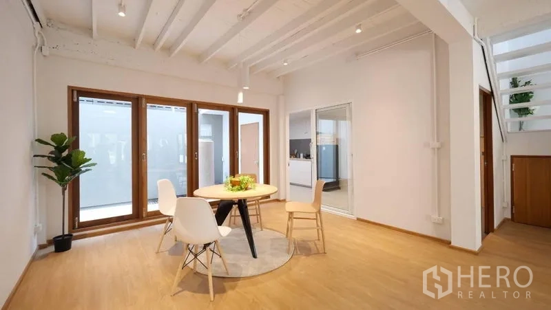 ทาวน์เฮาส์ ให้เช่าในKhlong Toei, Bangkok - มุมทานอาหาร โต๊ะกลม ประตูบานเลื่อนกระจก และเพดานคานเปลือย