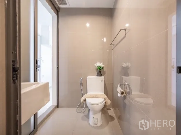 公寓 出售在Khlong Toei, Bangkok - 独立马桶区，配毛巾杆与推拉门，瓷砖中性色。