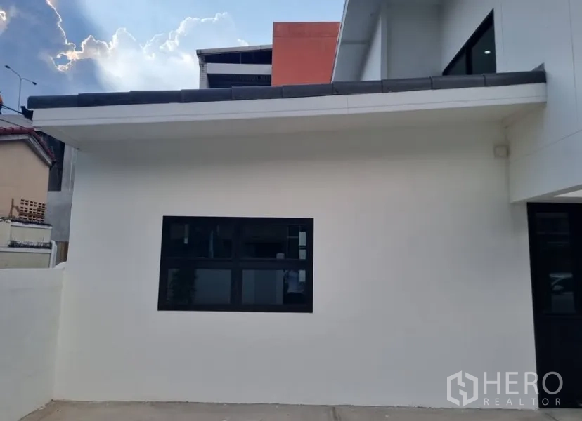 Detached House for rent in Suan Luang, Bangkok - Side elevation showing clean white facade and a horizontal picture window.