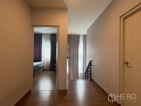 Detached House for rent in Bang Phli, Samut Prakan - Upstairs landing with wood flooring leading to bedrooms and staircase.