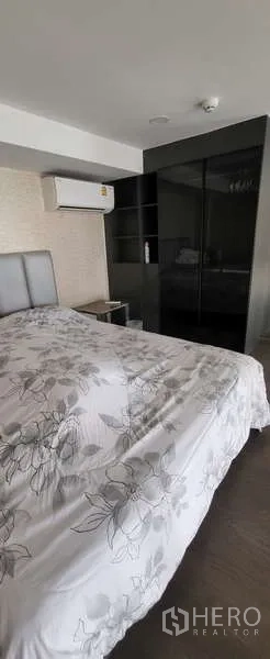 Condominium for rent - Bedroom view showing mirrored built-in wardrobe and air conditioner.