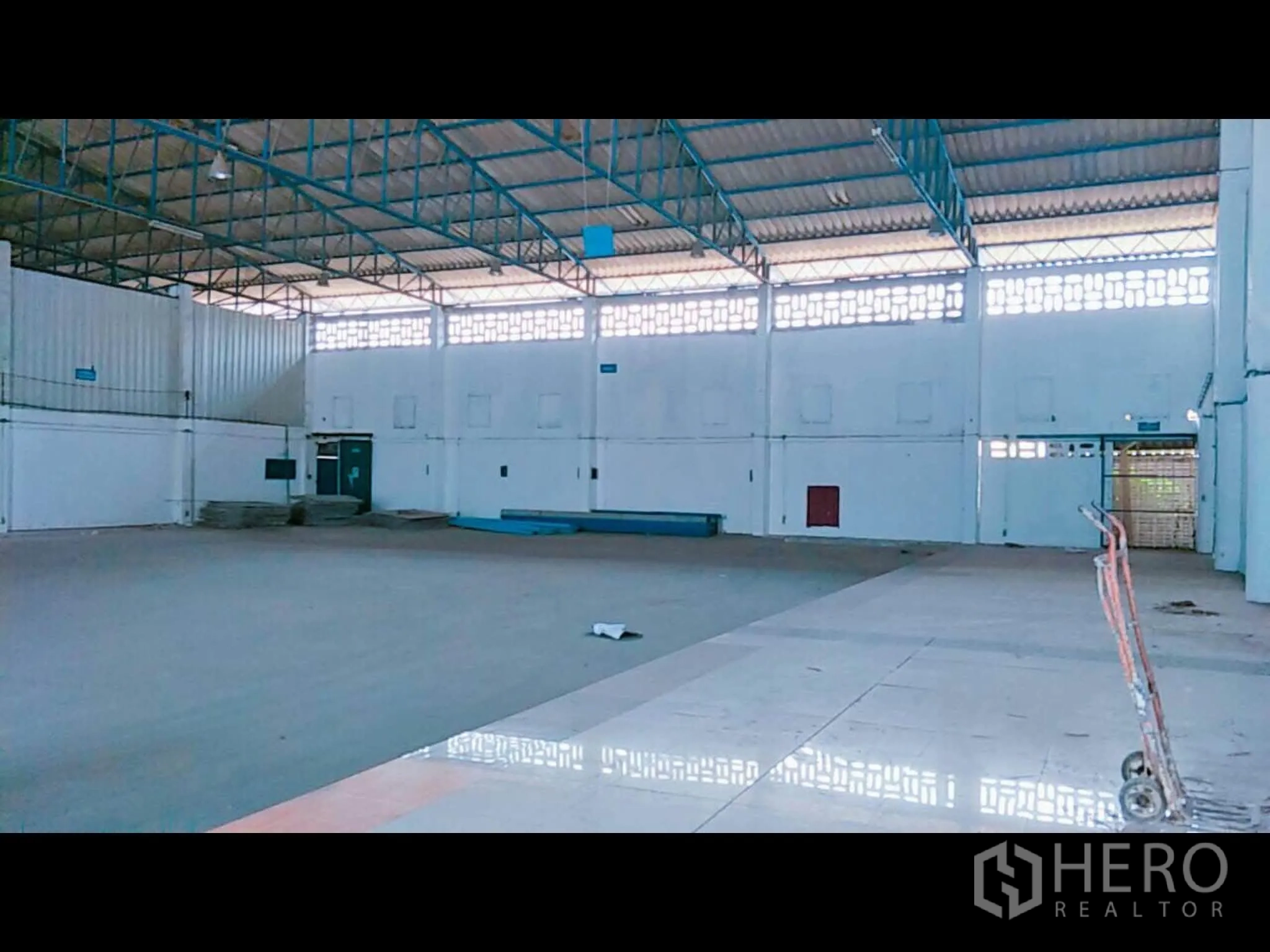 Warehouse for rent in Bang Phli, Samut Prakan - Large warehouse interior with tall roof trusses, ventilation blocks, and concrete floor.