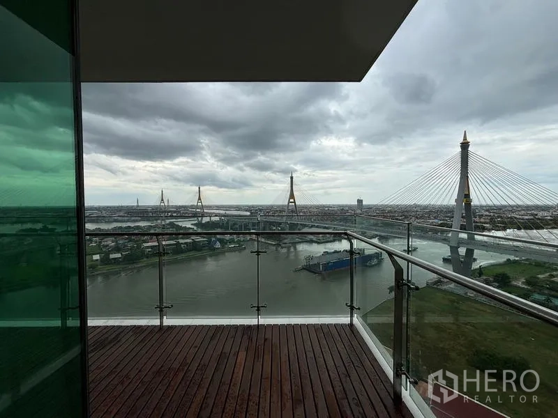 Condominium for rent - Corner balcony framing the wide river and multiple bridge pylons.