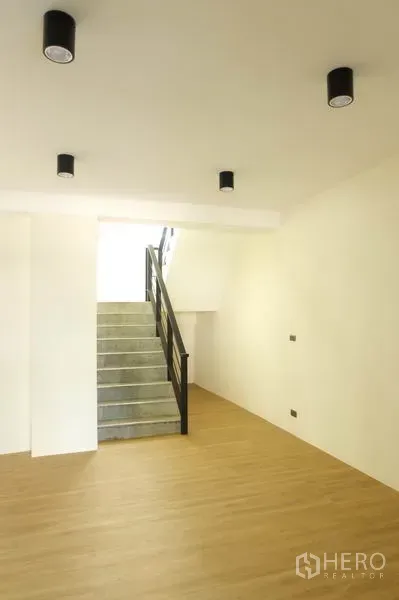 Home Office for rent in Wang Thonglang, Bangkok - Open-plan area with light wood floors and stairs, ideal for office or meeting space.