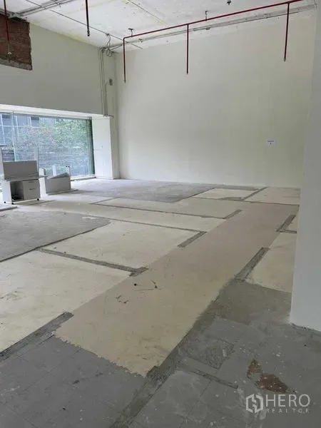 Office Space for rent in Watthana, Bangkok - Spacious corner workspace with glass wall and concrete subfloor ready for fit-out.
