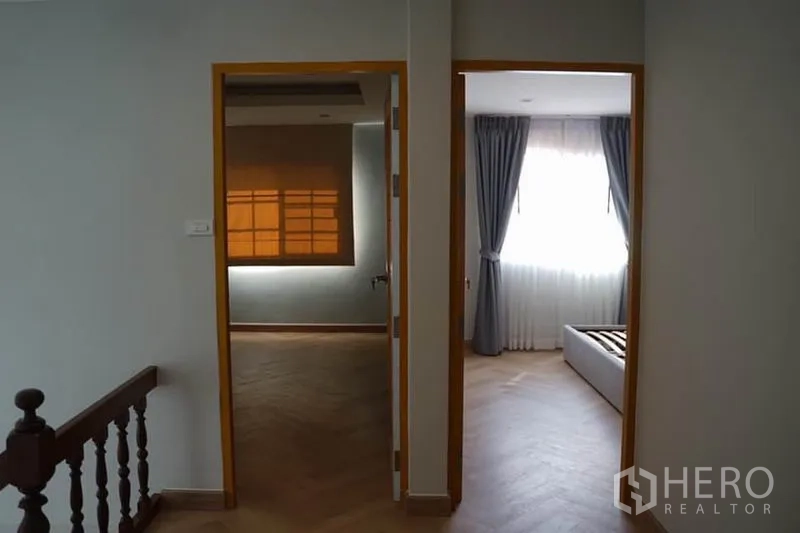 Detached House for rent in Wang Thonglang, Bangkok - Upper landing leading to two bedrooms with wood flooring and natural light.