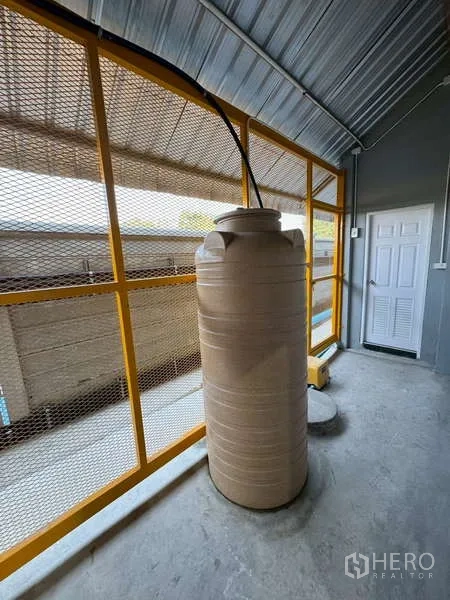 货栈 出租在Bang Phli, Samut Prakan - 金属屋顶下的蓄水罐，旁有网墙与水泵