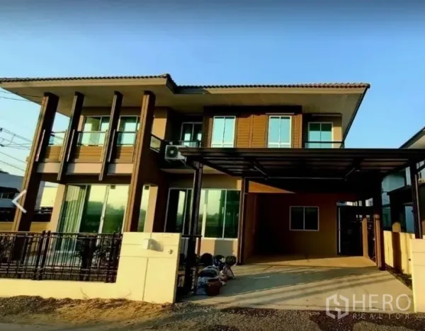Detached House for rent or sale in Pathum Thani - Modern two-storey detached house exterior with covered carport and fenced front yard in Thanyaburi.