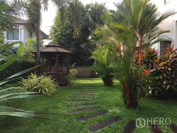 Detached House for sale in Khlong Sam Wa, Bangkok - Lush private garden with stepping-stone path and wooden gazebo.