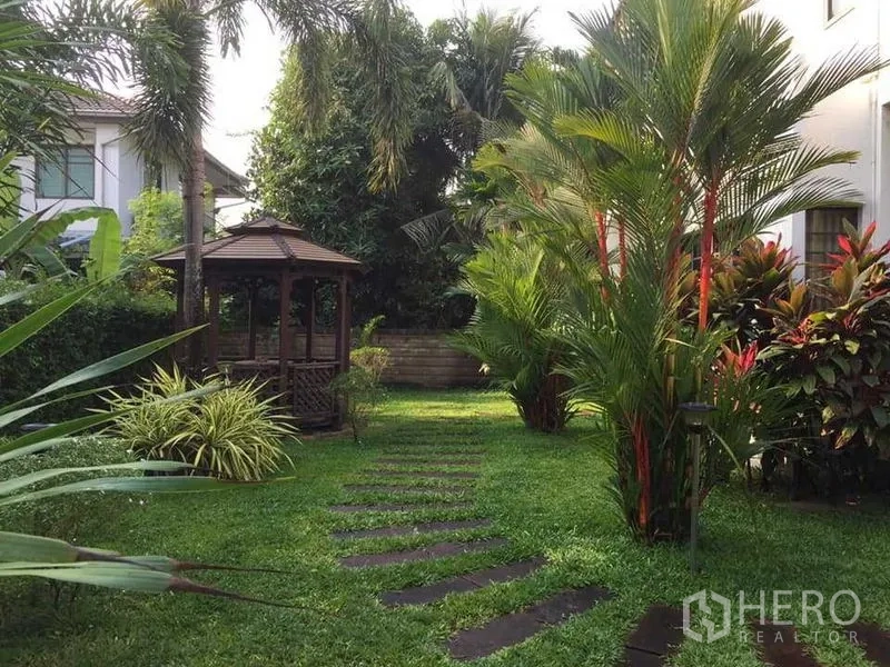 Detached House for sale in Khlong Sam Wa, Bangkok - Lush private garden with stepping-stone path and wooden gazebo.