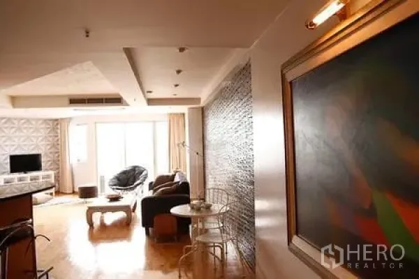 Condominium for rent in Ratchathewi, Bangkok - Bright condo living area with wood flooring, feature wall, large windows and lounge seating.