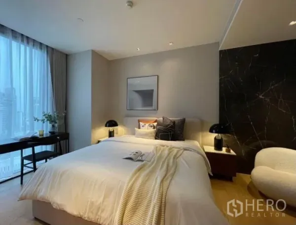 คอนโด ให้เช่าหรือขายในKhlong Toei, Bangkok - ห้องนอนหลัก เตียงคิง ผนังหินอ่อนสีดำ โต๊ะหัวเตียง และหน้าต่างบานใหญ่เห็นวิวเมือง