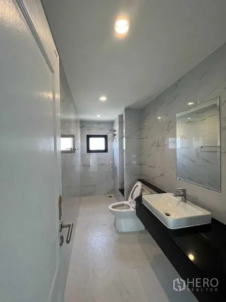 Home Office for rent - Modern bathroom with marble-look tiles, walk-in shower, toilet and long vanity.