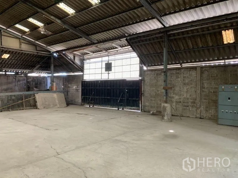 Warehouse for rent - Open loading area with large entry door and solid masonry walls.