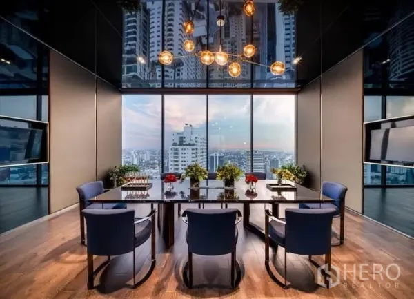 Condominium for rent in Watthana, Bangkok - Sky lounge dining and meeting room with chandelier and panoramic Bangkok views.