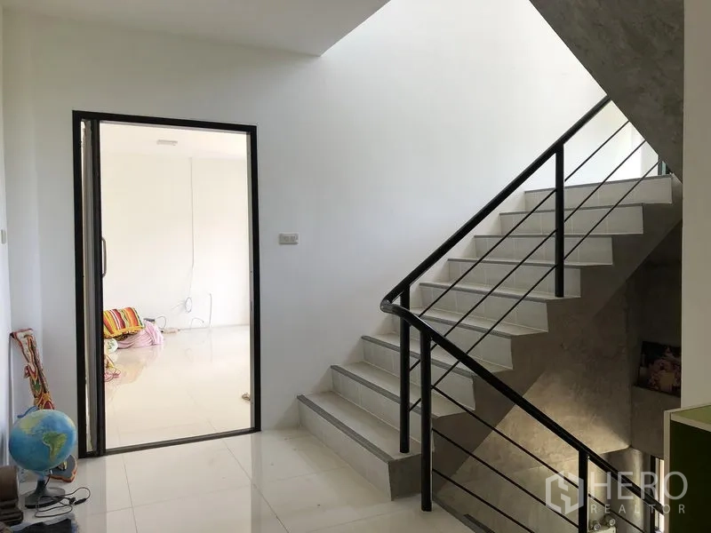 Factory for rent or sale in Lat Lum Kaeo, Pathum Thani - Bright stairwell with metal handrail leading to upper office rooms.