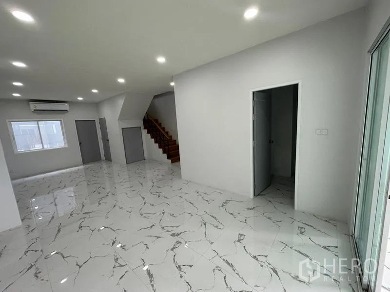 Home Office for rent or sale - Open-plan ground floor with marble-look tiles, recessed lights, staircase and doors ideal for a home office layout.