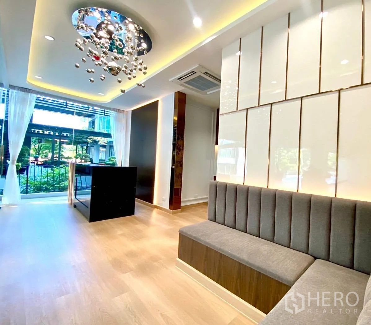 Office Space for rent - Lounge corner with upholstered bench, paneled wall and view to landscaped walkway.