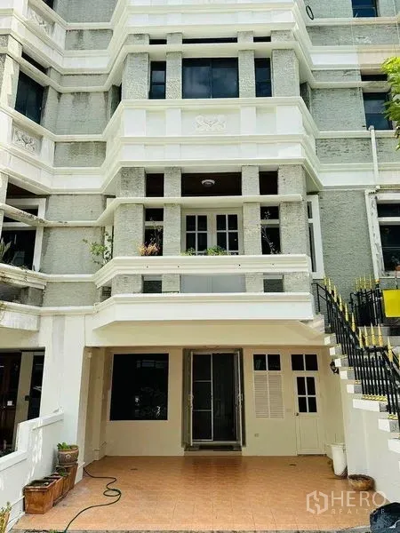 Home Office for rent in Watthana, Bangkok - Multi-storey home office facade with balconies, stairs, and covered parking.