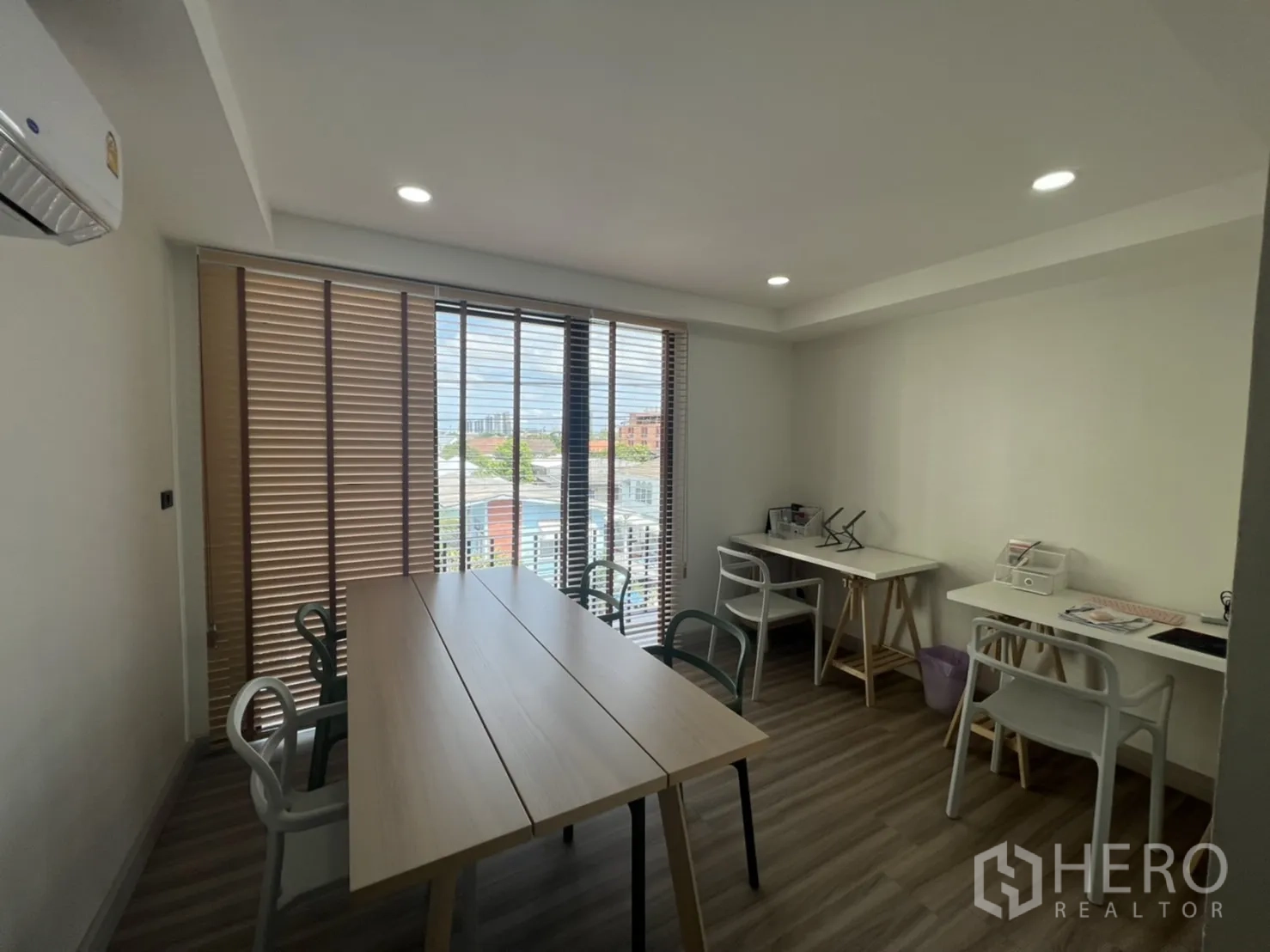 Home Office for rent or sale in Phra Khanong, Bangkok - Meeting room with long table, task desks and a wall of windows.