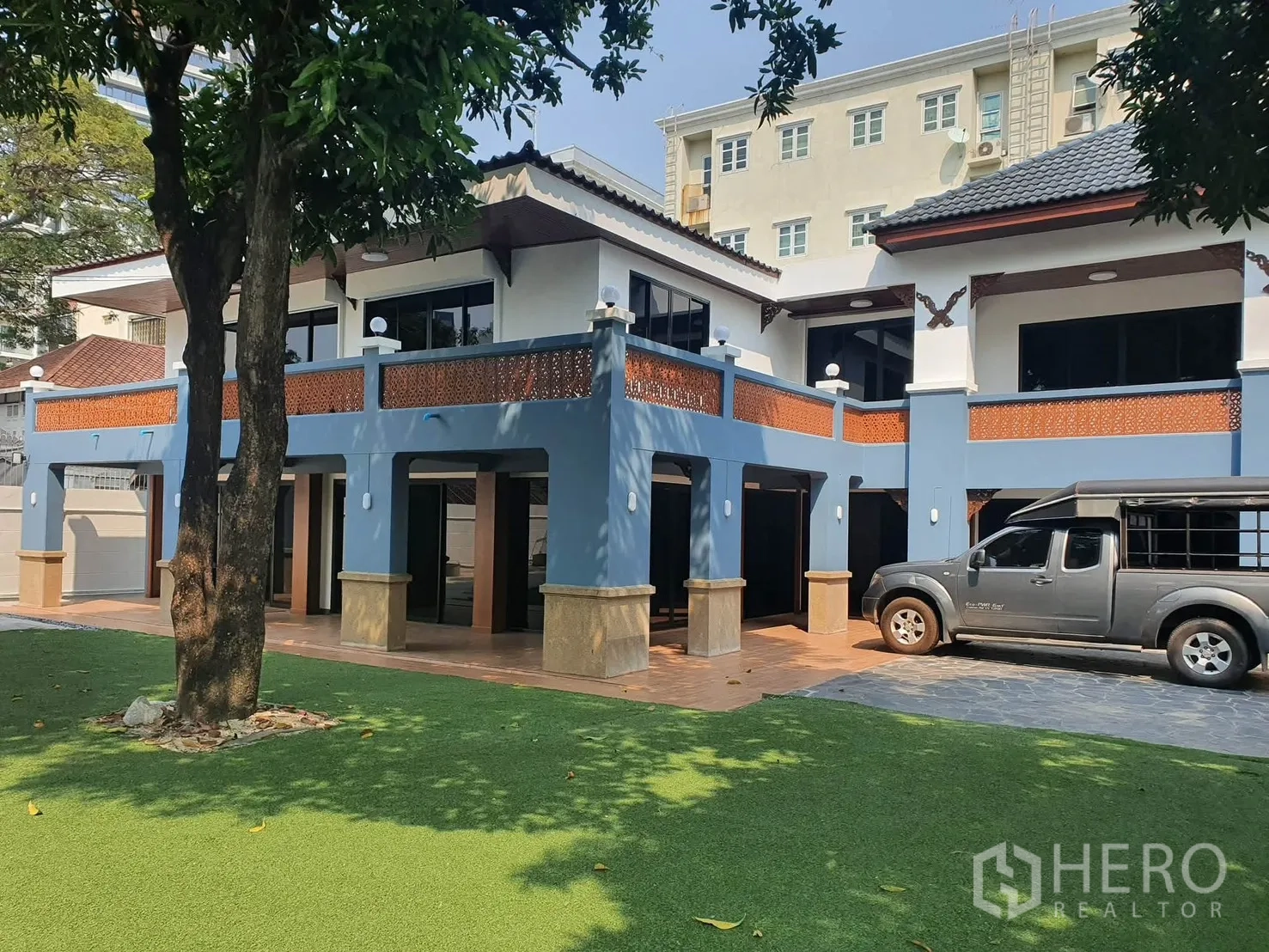 Detached House for rent in Sathon, Bangkok - Two-storey blue-and-white house exterior with covered parking and wide veranda.