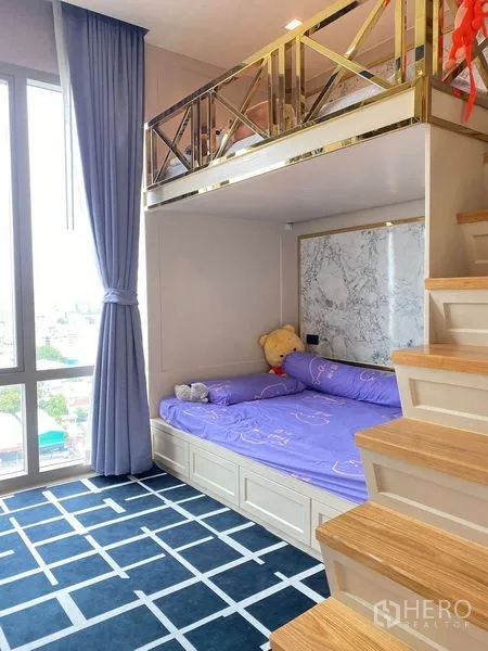 Condominium for sale in Bang Kho Laem, Bangkok - Loft-style second bedroom with stairs, built-in storage and large window.