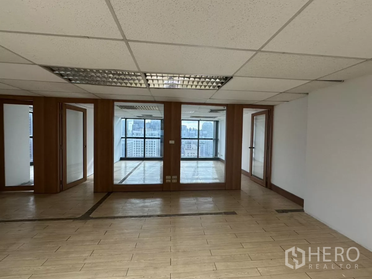 Office Space for rent in Watthana, Bangkok - Glass-enclosed meeting rooms facing floor-to-ceiling windows with Bangkok skyline view.