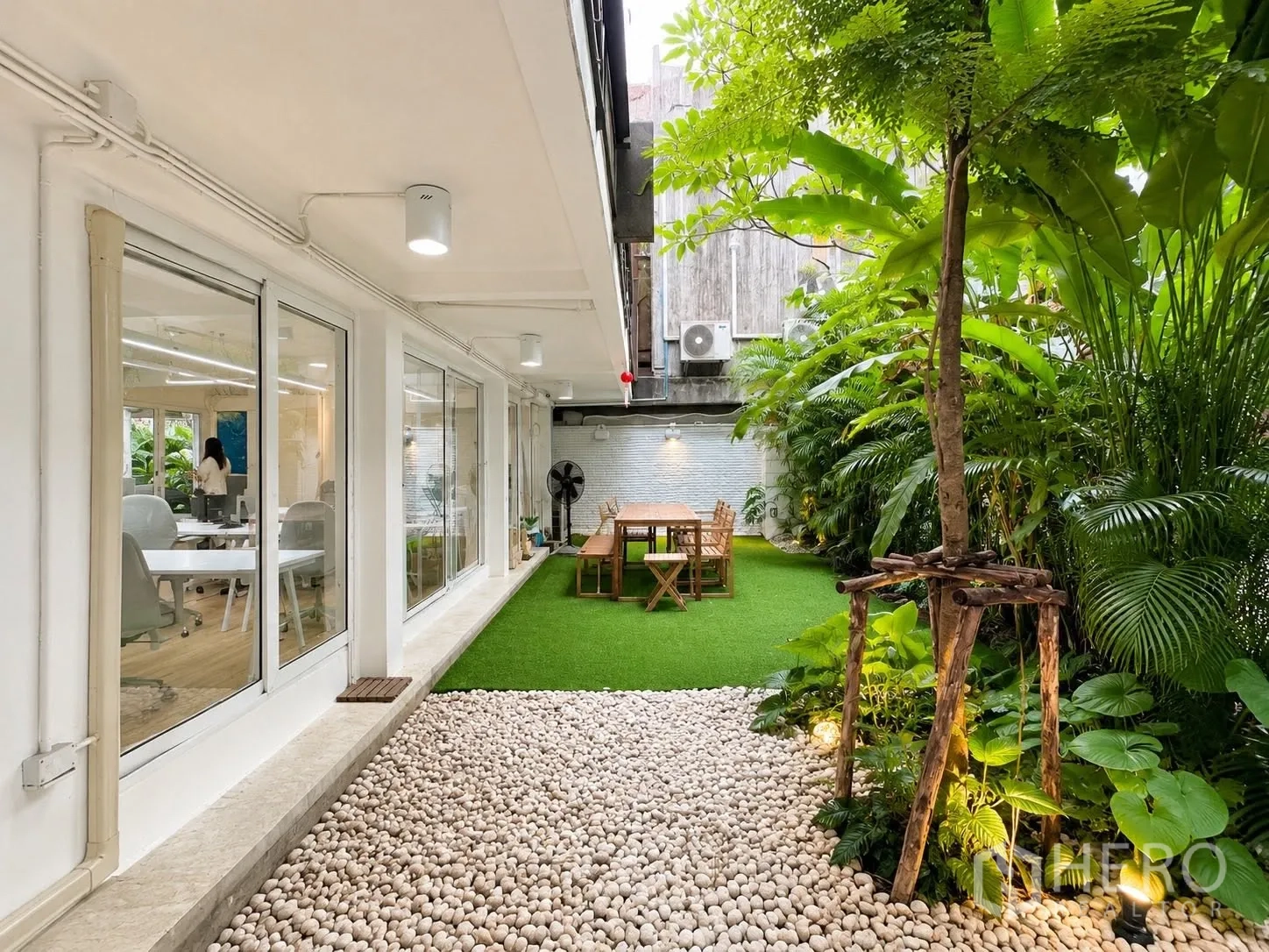 Office Space for rent in Phaya Thai, Bangkok - Landscaped garden with lawn, pebbles and seating outside the office.