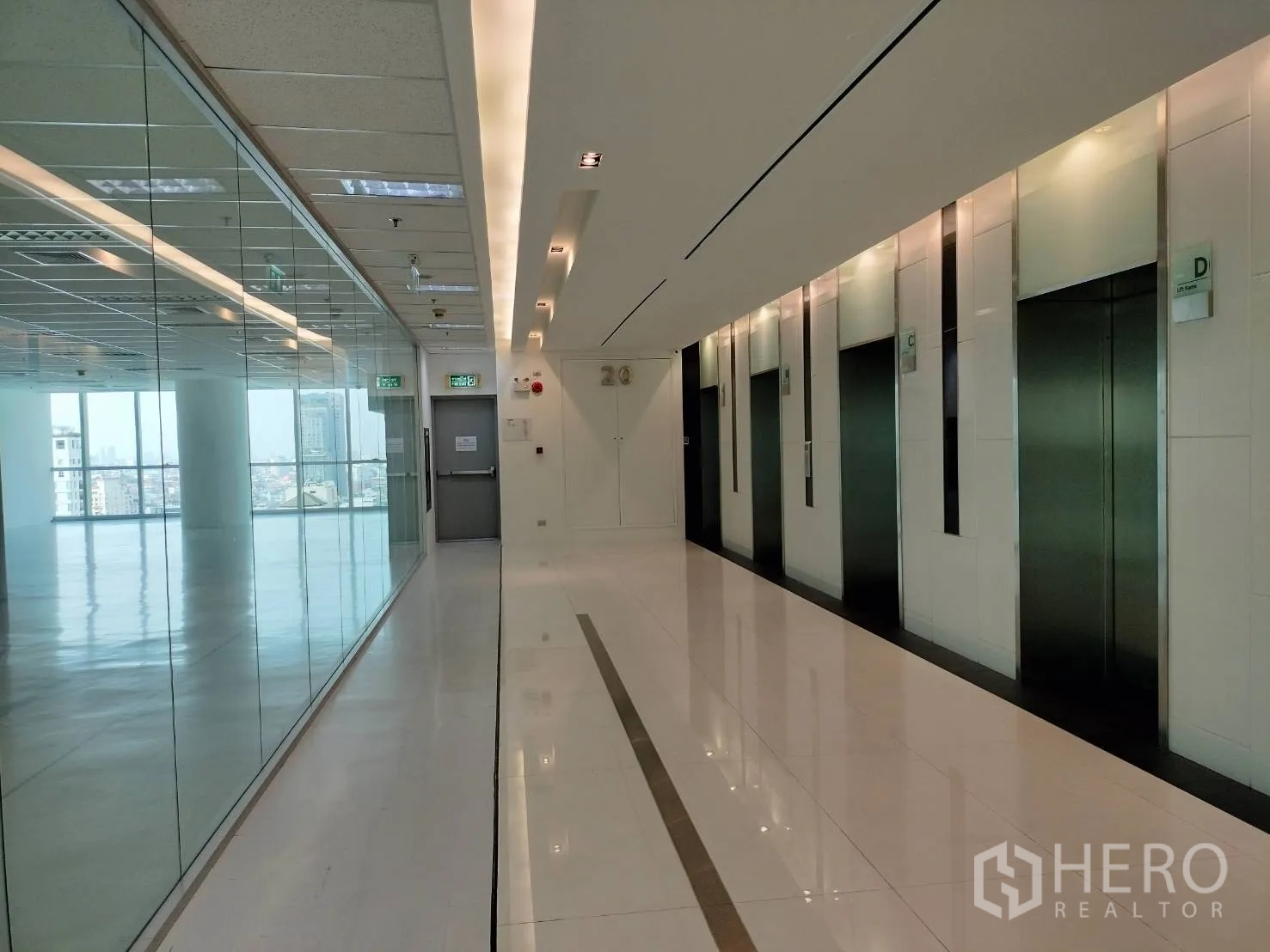 Retail Space for rent in Sathon, Bangkok - Modern elevator lobby with multiple lifts beside the glass-lined retail space.