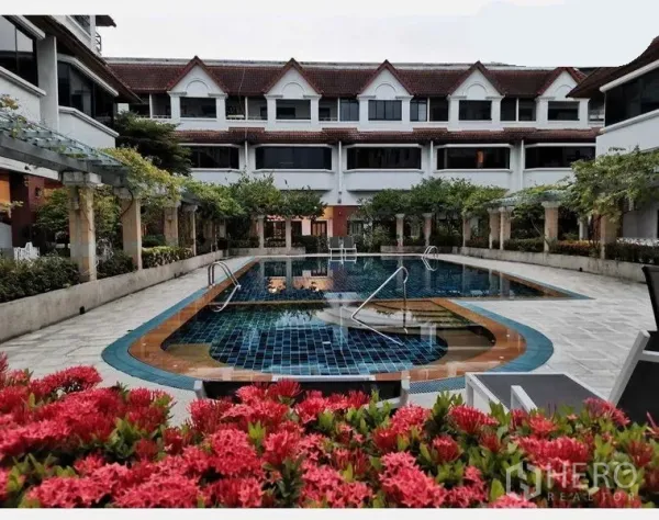 Townhouse for rent in Khlong Toei, Bangkok - Courtyard swimming pool surrounded by three‑story townhouses and lush greenery in a Bangkok complex.