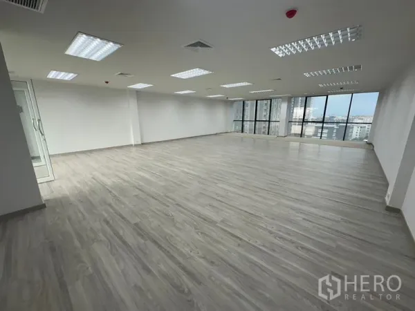 Office Space for rent - Corner office area with panoramic glazing, ceiling air-conditioning vents and a glass entry door