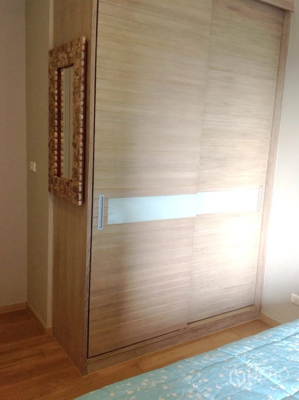 Condominium for rent or sale in Watthana, Bangkok - Light wood sliding-door closet with a decorative mirror.