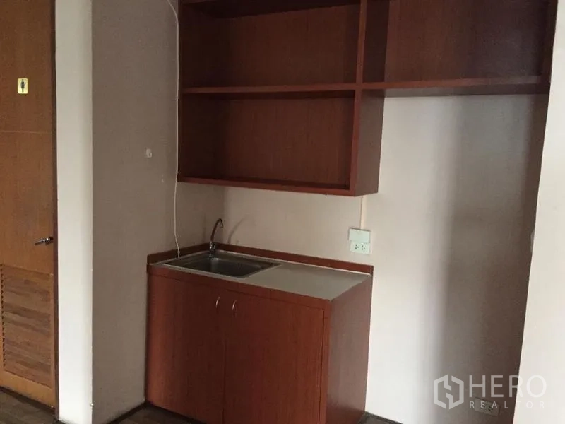 Office Space for sale in Watthana, Bangkok - Compact pantry with sink, countertop and open shelving in wood cabinetry.