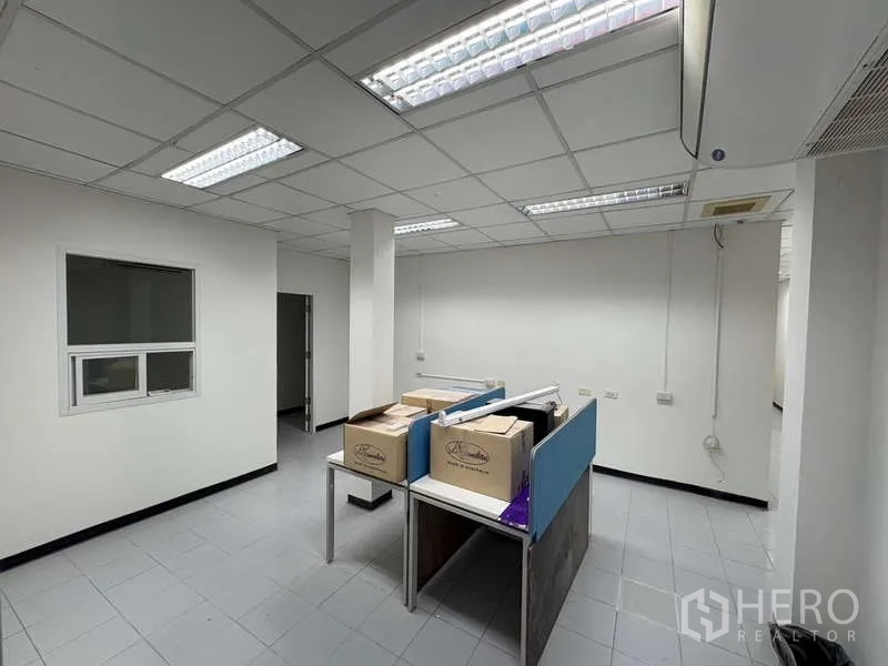 Office Space for rent in Khlong Toei, Bangkok - Small office zone with workstations under grid ceiling lights.