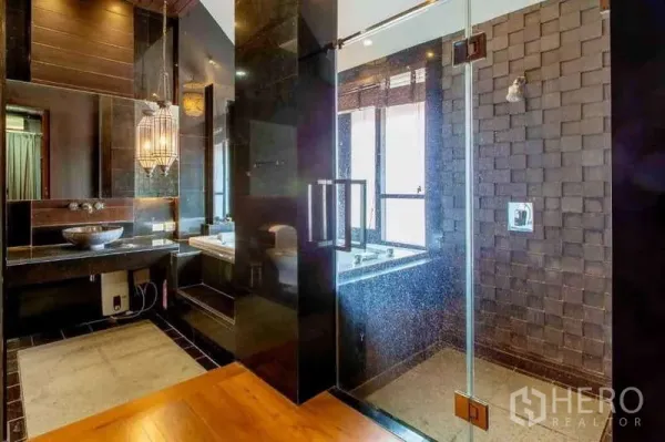 Detached House for sale in Bueng Kum, Bangkok - Luxury bathroom with glass shower, soaking tub by the window, vessel sink and lantern lighting.