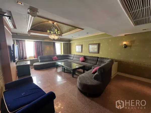 Retail Space for rent in Watthana, Bangkok - Chandelier-lit lounge with green walls and a gray L-shaped sofa set.