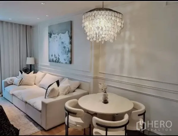 公寓 出售在Khlong Toei, Bangkok - 客厅全景：白色沙发、圆形餐桌与贝壳造型吊灯。