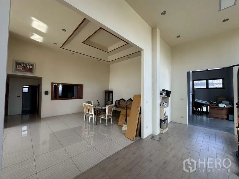 Home Office for sale in Lam Luk Ka, Pathum Thani - Double-height living and dining area with recessed ceiling, glossy tile flooring and abundant natural light