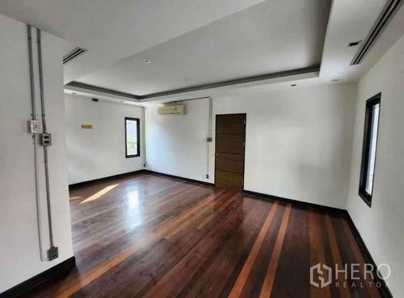 带办公室的家 出租在Lat Phrao, Bangkok - 宽敞办公房，抛光木地板、白色墙面与筒灯，旁有通道门。