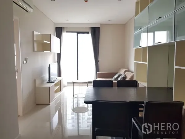 คอนโด ให้เช่าในRatchathewi, Bangkok - ห้องนั่งเล่นและทานอาหารสว่างในคอนโดราชเทวี มีโซฟา โต๊ะทานอาหาร ชั้นวางบิวท์อิน และประตูกระจกสูงจรดเพดานออกระเบียง