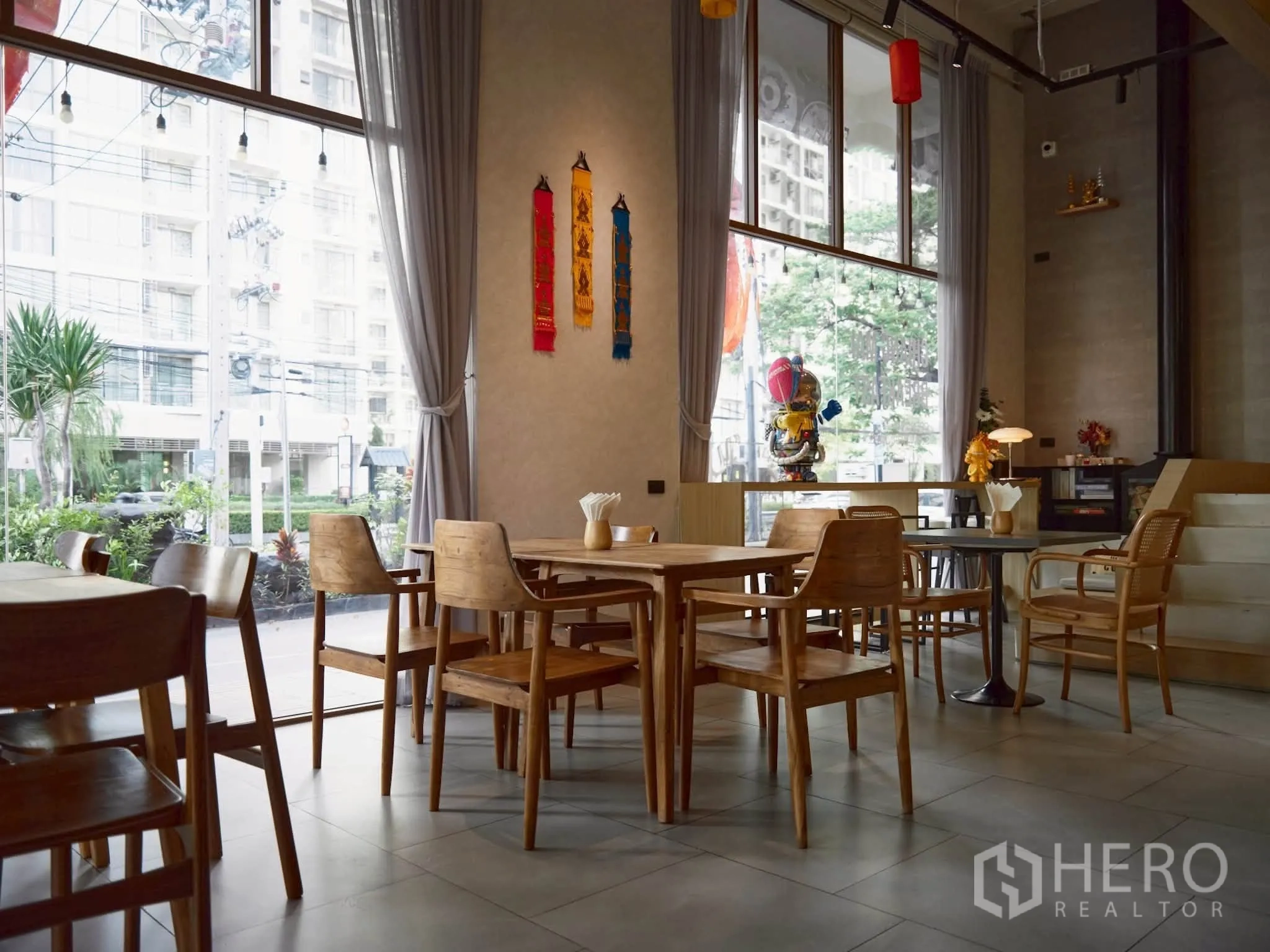 Retail Space for rent in Watthana, Bangkok - Double-height space with floor-to-ceiling windows and a street view.