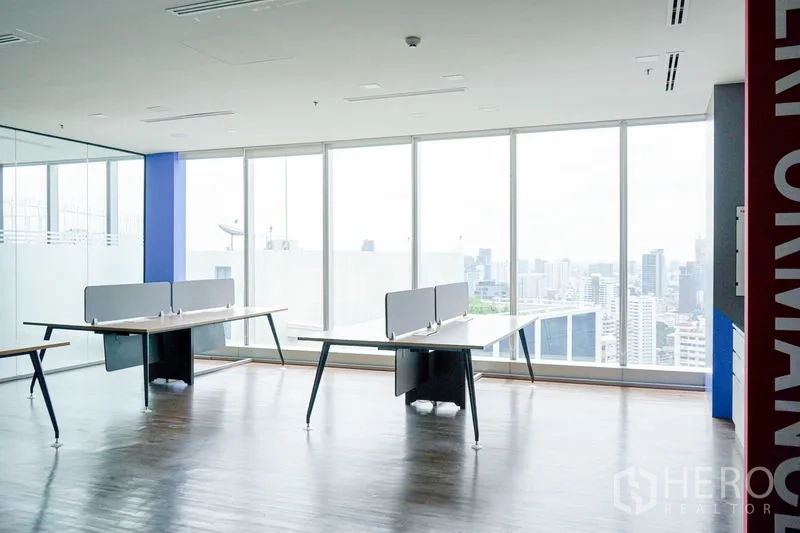 Office Space for rent in Khlong Toei, Bangkok - Open-plan workspace with large windows, wood flooring, and sweeping skyline view.