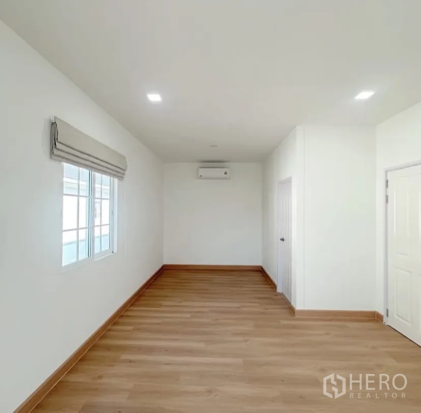 บ้าน ให้เช่าในMueang Samut Prakan, Samut Prakan - ห้องอเนกประสงค์ทรงยาว พื้นไม้ ผนังขาว และเครื่องปรับอากาศ