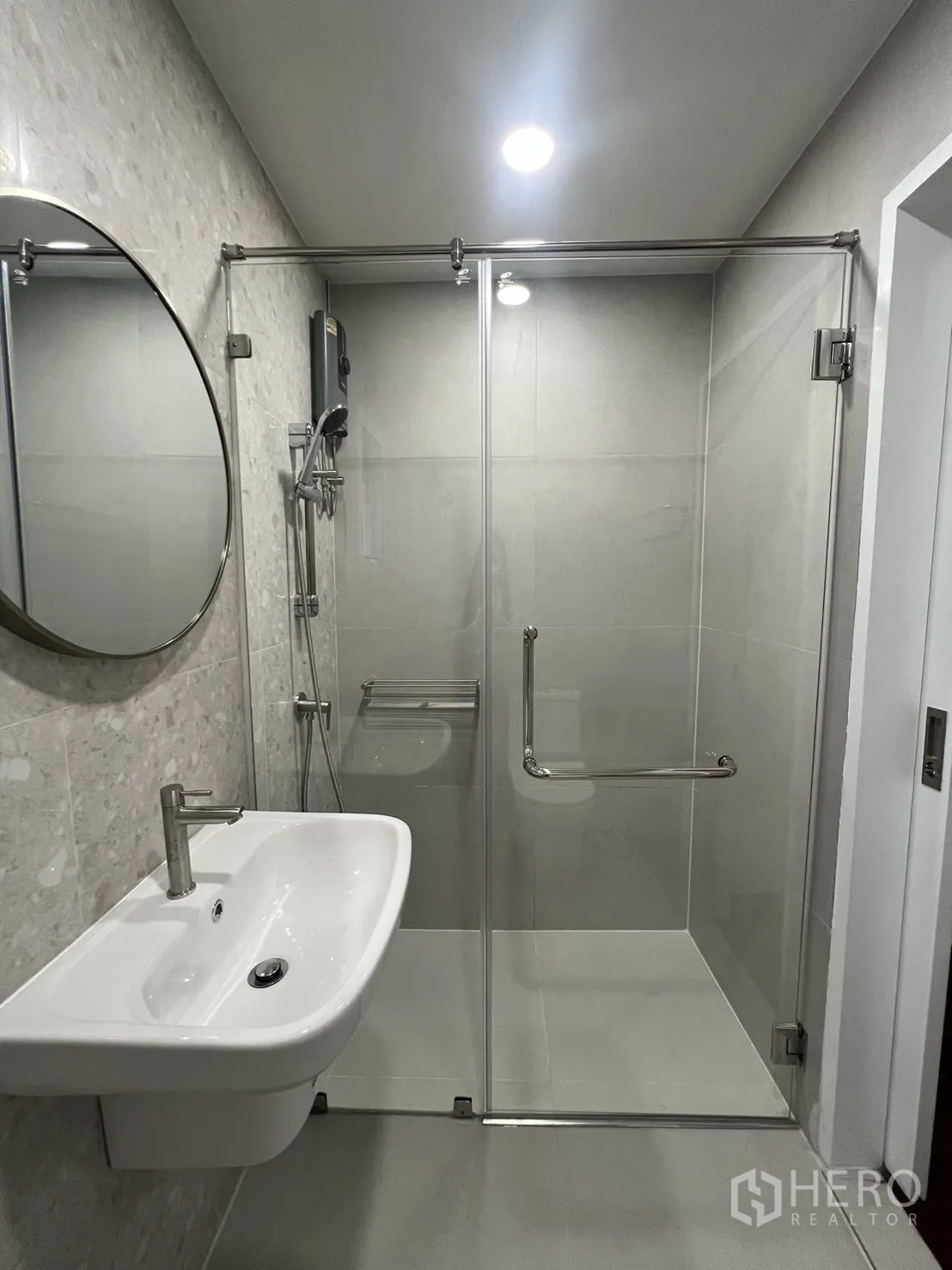 Detached House for rent in Saphan Sung, Bangkok - Upstairs bathroom with glass shower enclosure and wall-mounted sink.