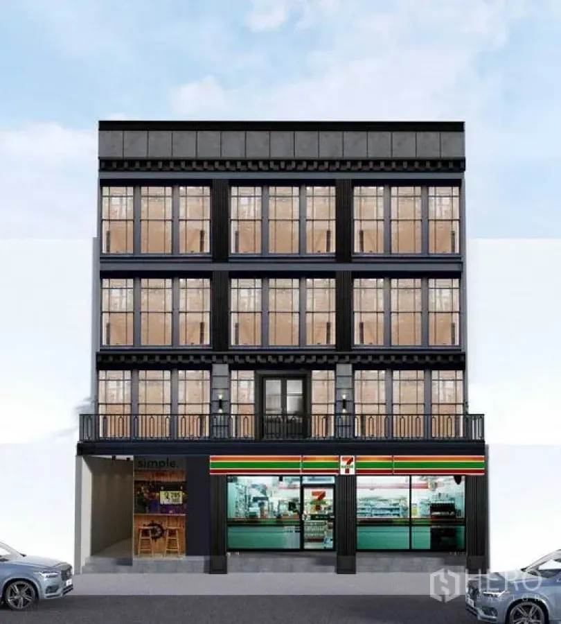 Shophouse for rent in Watthana, Bangkok - Four-storey shophouse facade with large grid windows, balconies, and a ground-floor retail frontage in central Bangkok.