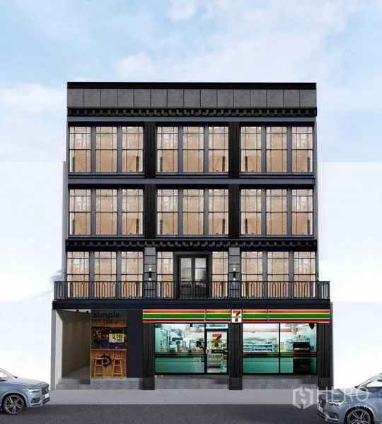 Shophouse for rent in Watthana, Bangkok - Four-storey shophouse facade with large grid windows, balconies, and a ground-floor retail frontage in central Bangkok.