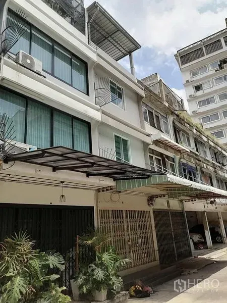 Shophouse for rent in Bang Rak, Bangkok - Renovated multi-storey shophouse exterior with awnings and large windows on a quiet Silom lane.